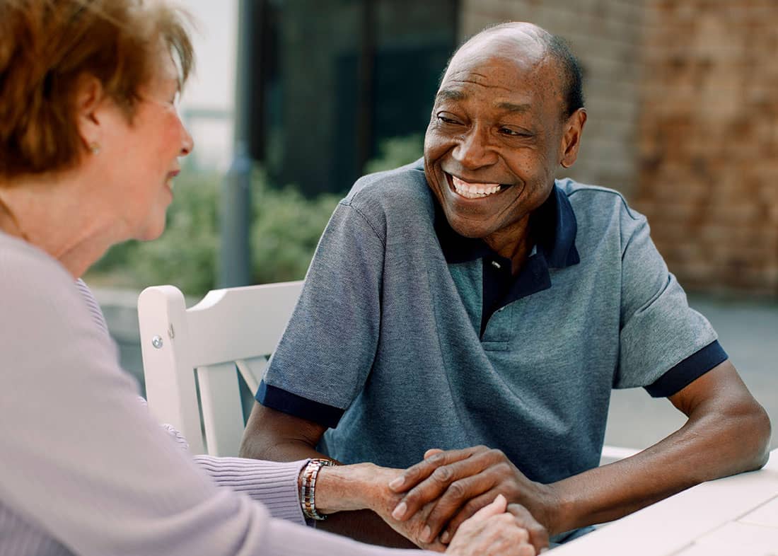 Elderly man outside chatting with a woman