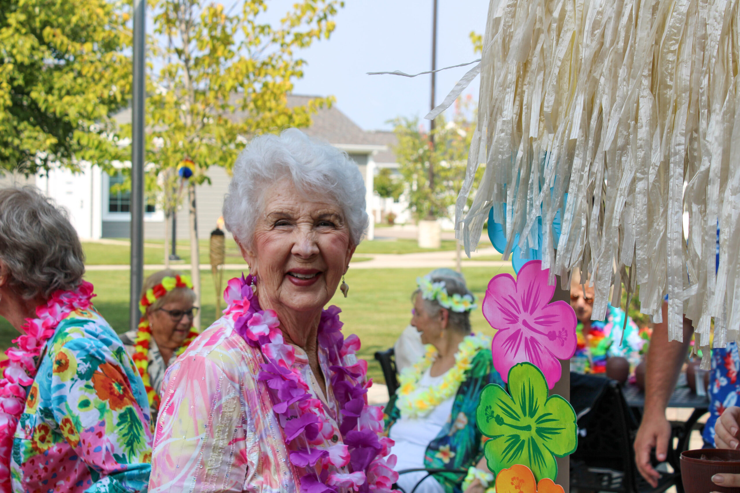 Woman at Luau event at senior living community.